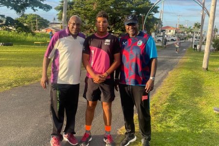 Jonathan Van Lange receiving valuable tips from former Guyana players Mark Harper and Carl Hooper recently. (Donald Duff photo)