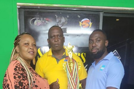 Captain of Big Boss Female Team Charlyn Barnwell receives the third-place trophy with medals and a sponsorship cheque  from Mortimer Robertson (right), Head of Business Development, of VSH United (Guyana) Inc. Also in the photo is the co-organizer of the event, Roderick Harry.