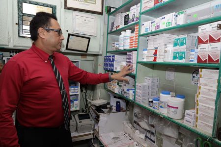 Wazir’s Pharmacy owner Wazir Hosein does an inventory check at his business place along High Street, San Fernando, yesterday.KRISTIAN DE SILVA