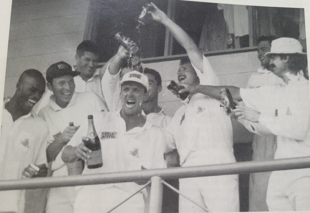 The England team celebrate their astonishing victory, dousing Man-of-the-Match Alec Stewart with Tetley Bitter, their sponsor’s brew. Stewart, champagne in hand, is flanked by (left to right, front row) Chris Lewis, Skipper Mike Atherton, Robin Smith and Jack Russell. Tetley Bitter sponsored England’s cricket team from 1994 to 1998. (Photo from Caribbean Red Stripe Cricket Quarterly, Vol # 4, Issue # 3, July/September 1994)