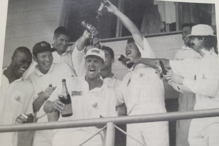 The England team celebrate their astonishing victory, dousing Man-of-the-Match Alec Stewart with Tetley Bitter, their sponsor’s brew. Stewart, champagne in hand, is flanked by (left to right, front row) Chris Lewis, Skipper Mike Atherton, Robin Smith and Jack Russell. Tetley Bitter sponsored England’s cricket team from 1994 to 1998. (Photo from Caribbean Red Stripe Cricket Quarterly, Vol # 4, Issue # 3, July/September 1994)