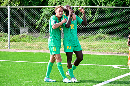 Omari Glasgow (right) being congratulated by Stephen Duke-McKenna after scoring the opening goal for Guyana against hosts Antigua and Barbuda in the CONCACAF Nations League