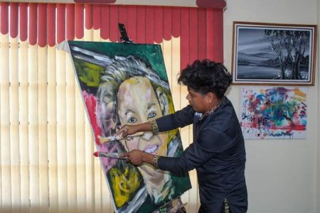 Winston Alexander applying the final touches to his painting