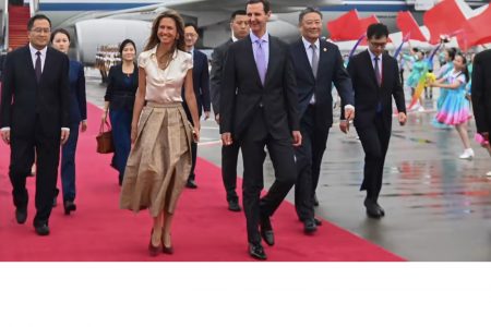 Syrian President Bashar Assad, center right, arrives in Hangzhou on Sept. 21, ahead of a meeting with Chinese President Xi Jinping. (Xinhua via AP)