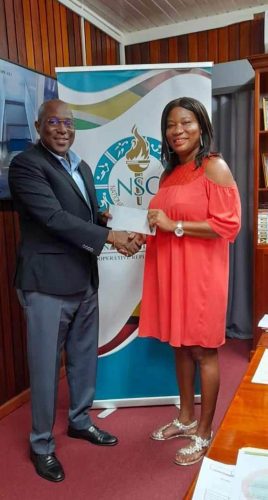 Director of Sport Steve Ninvalle
presents a sponsorship cheque to Dawn Britton, mother of national table tennis star, Shemar Britton to assist him to attend a high level training camp following his participation next month at the Pan Am Games in Santiago Chile. (Photo courtesy Department
of Sport)