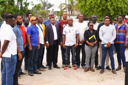 Minister in the Ministry of Public Works Deodat Indar (centre) with the contractors and ministry officials yesterday. (DPI photo)