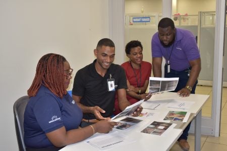 Courts staff reviewing entries for “Operation Home Transformation” as they get ready to pick a winner. (Courts photo)