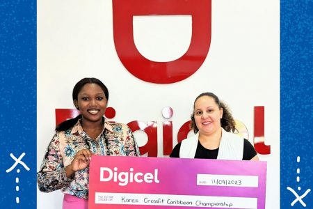 Gabriella Chapman (left), Digicel’s Communications Manager handing over the sponsorship cheque to Jordana Ramsay- Gonsalves, Event Organiser