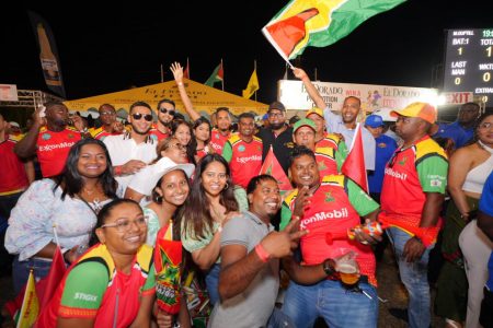  President Irfaan Ali posed with fans of the Guyana Amazon Warriors at the National Stadium at Providence yesterday. (Office of the President photo)