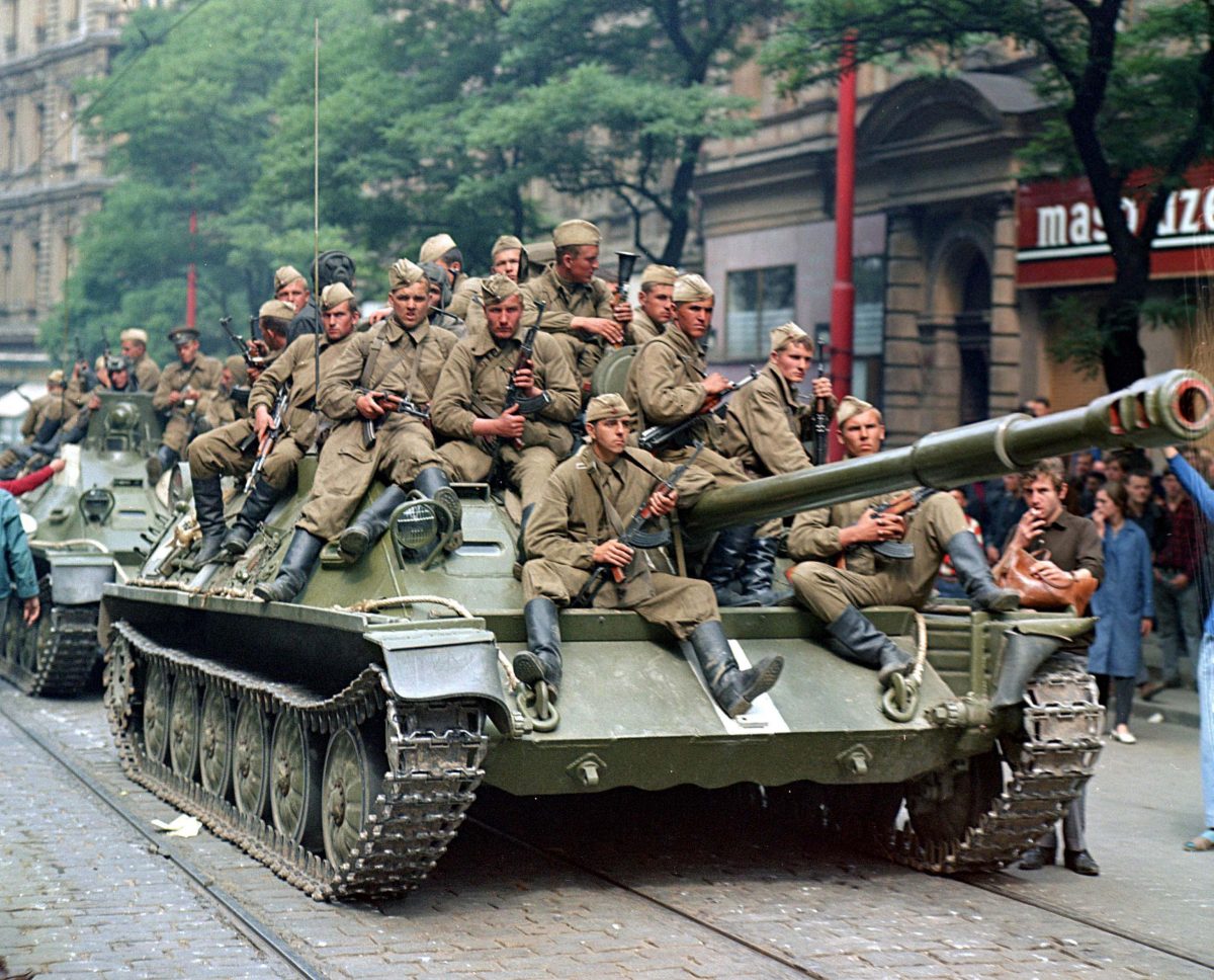 Soviet Army soldiers sit on their tanks in front of the Czechoslovak Radio station building in central Prague, August 21, 1968.        REUTERS/Libor Hajsky