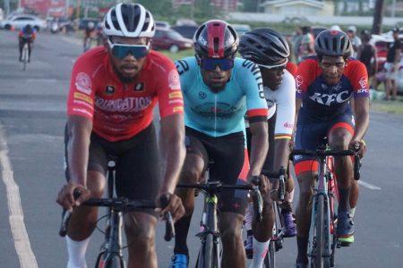 Star cyclist, Jamual John (left) of Team Foundation brought his talents back to Guyana and rode off with the spoils of the Team Alanis sponsored 50-mile road race yesterday. He led Curtis Dey (right) and Briton John (second from left) onto the podium. (Emmerson Campbell photo)