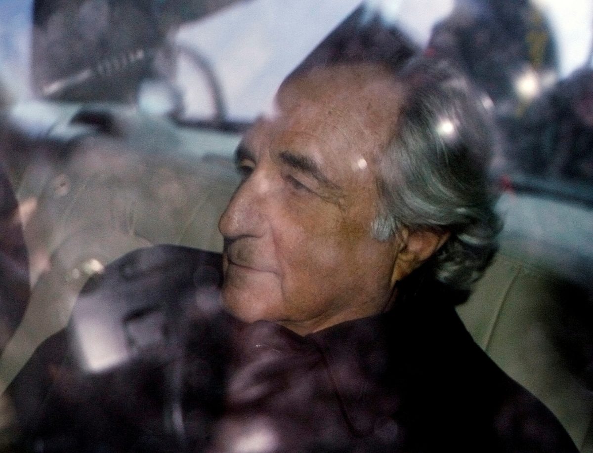 FILE PHOTO: Bernard Madoff is escorted in a vehicle from Federal Court in New York January 5, 2009. REUTERS/Lucas Jackson/File Photo