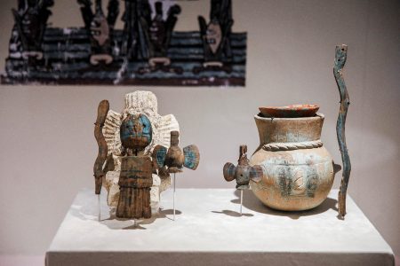 A carved copal figure depicting a tlaloque, or helper of the Aztec rain god Tlaloc, is pictured (left) along with its wooden mask, scepter and water jugs, next to a Tlaloc modeled ceramic pot (right) with similar adornments, part of the exhibition “Insignia of the Gods, the wood in the Templo Mayor,” at the Templo Mayor Museum in Mexico City, Mexico September 27, 2023. REUTERS/Raquel Cunha 