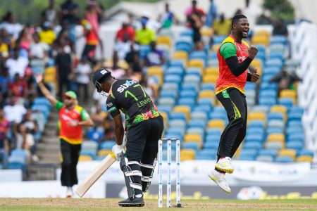 Romario Shepherd (R) of Guyana Amazon Warriors celebrates the dismissal of Evin Lewis (L) of Saint Kitts & Nevis Patriots yesterday. (Photo by Randy Brooks/CPL T20 via Getty Images)
