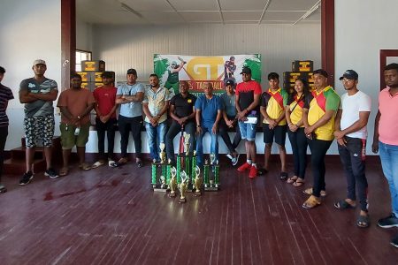 GT Beer Brand Manager Dwayne Bristol (centre) poses with several players and members of the coordinating team at the official launch of the East Coast Demerara edition of the GT Beer 5/5 tapeball cricket competition on Saturday