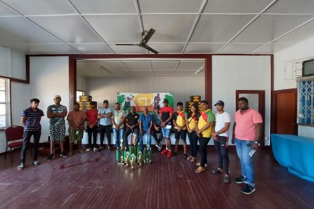 GT Beer Brand Manager Dwayne Bristol (centre) poses with several players and members of the coordinating team at the official launch of the East Coast Demerara edition of the GT Beer 5/5 tapeball cricket competition.