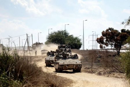Israeli military vehicles drive near Israel's border with the Gaza Strip in southern Israel on Oct. 15, 2023. Photo by Reuters