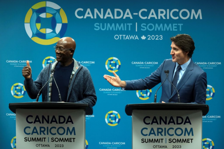 Canadian Prime Minister Justin Trudeau, right, and Prime Minister of Trinidad Tobago Keith Rowley wave to President of Guyana Mohamed Irfaan Ali who had to leave a news conference to catch a plane following the Canada Caricom Summit on Thursday. (Adrian Wyld/The Canadian Press via AP)
