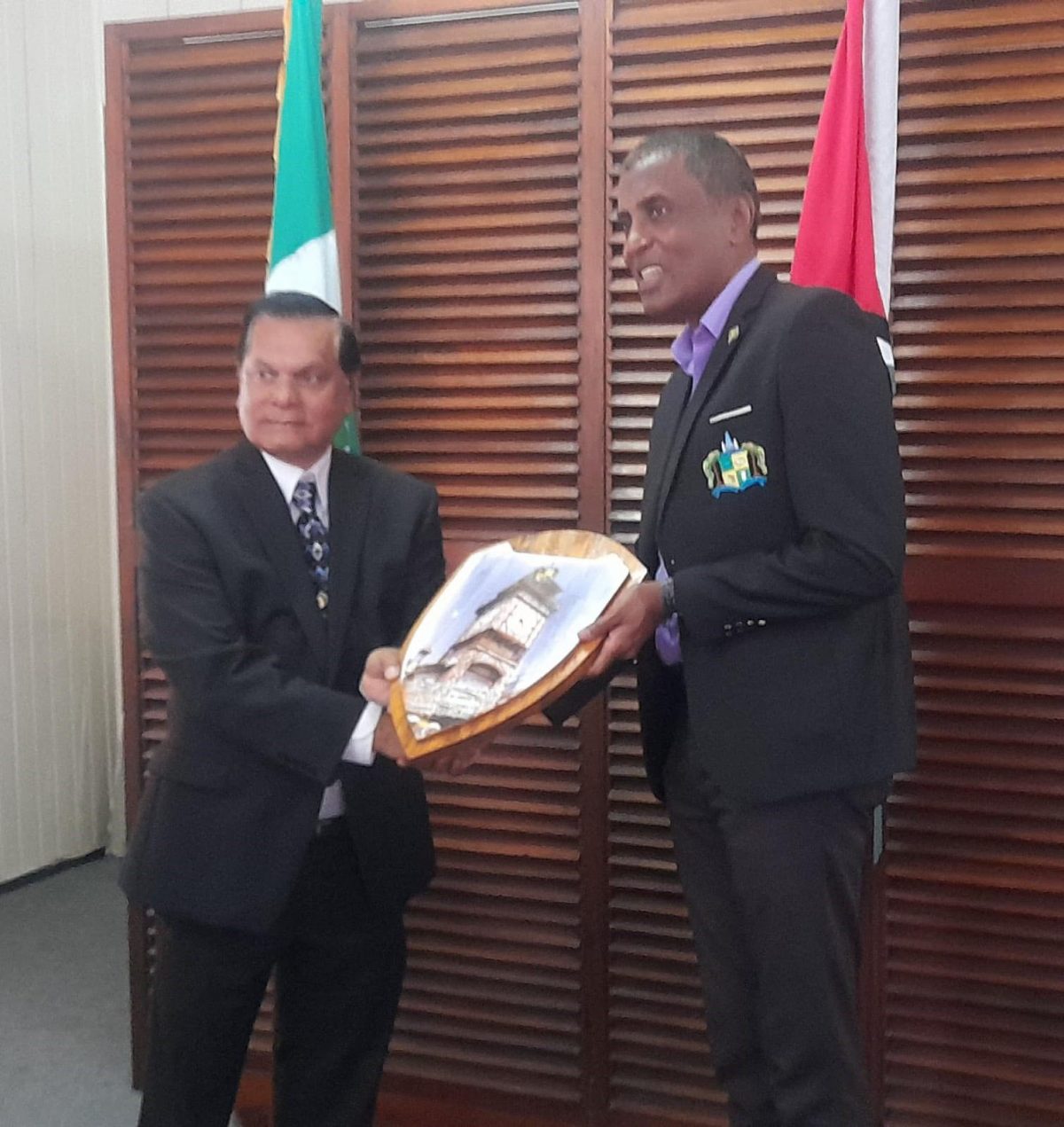 City Mayor Alfred Mentore (right) presenting a gift to visiting mayor from Arima, Balliram Maharaj 
