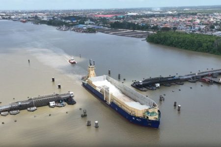 The barge “Motti” with tug “Mega” at the rear, transiting the Demerara Harbour Bridge (BK International photo)
