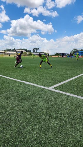 A scene from the Georgetown (brown) and Berbice encounter at the National Training Center in the Thunderbolt Flour Power Under-17 Academy Football Championships yesterday. 
the National Training Center.