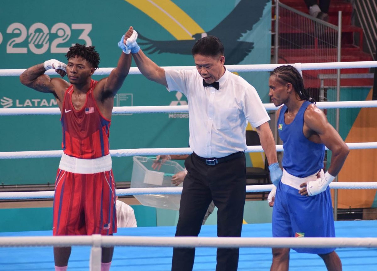 Refeeree, Maximo Abalos of the Philippines raises the hand of Jahmal Harvey following his unanimous points win against Keevin Allicock in their 57kg bout yesterday. (GOA/Akeem Green photos) 