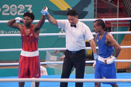 Refeeree, Maximo Abalos of the Philippines raises the hand of Jahmal Harvey following his unanimous points win against Keevin Allicock in their 57kg bout yesterday. (GOA/Akeem Green photos) 
