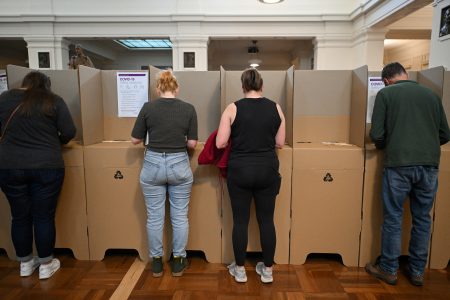 Voters are seen at the ballot box at the Old Australian Parliament House, during The Voice referendum in Canberra, Australia, October 14, 2023. REUTERS/Tracey Nearmy