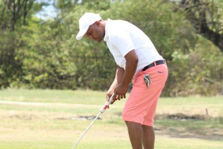 Defending champion Avinash Persaud goes for a putt on day one
