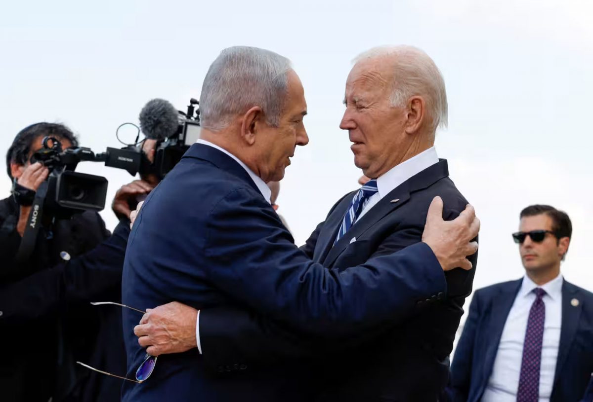 U.S. President Joe Biden is welcomed by Israeli Prime Minister Benjamin Netanyahu in Tel Aviv on Oct. 18 as he visits Israel amid its conflict with Hamas.   © Reuters 
