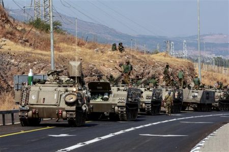 A convoy of Israeli Armoured Personnel Carriers drives on a road near Israel's border with Lebanon, northern Israel, October 9, 2023. Reuters
