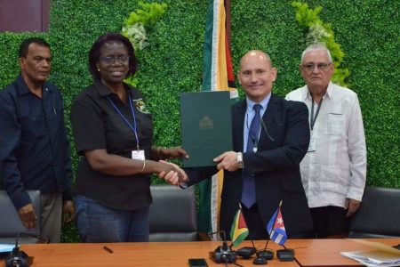 Ministry of Agriculture Permanent Secretary, Delma Nedd (second from left) exchanging the MoU with Cuban Ambassador to Guyana, Jorge Francisco Luis. (Department of Public Information photo)