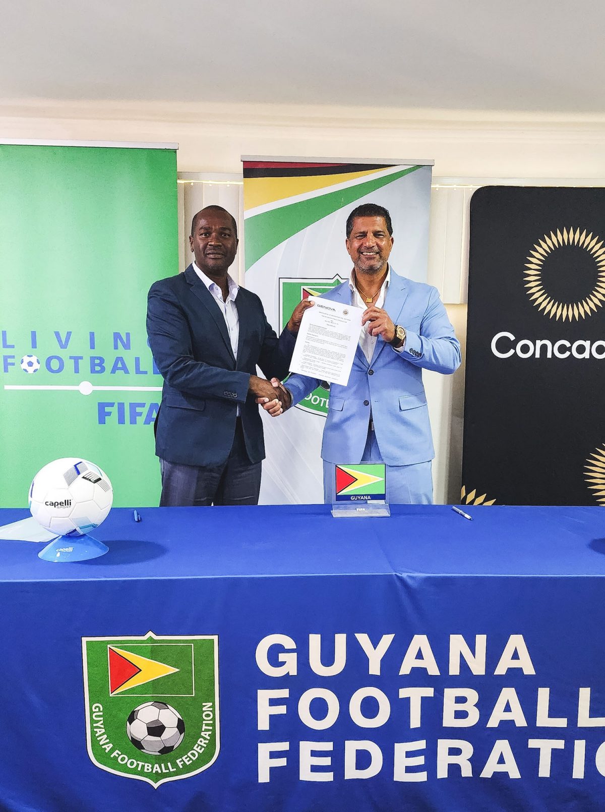 GFF President Wayne Forde (left) displaying the signed MoU with RMFC co-owner and President Steve Nijjar.

