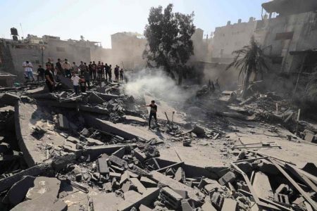 Palestinians search for survivors and the bodies in the rubble of buildings destroyed during Israeli bombardment, in Khan Yunis in southern Gaza Strip on Oct. 26, 2023. (AFP)