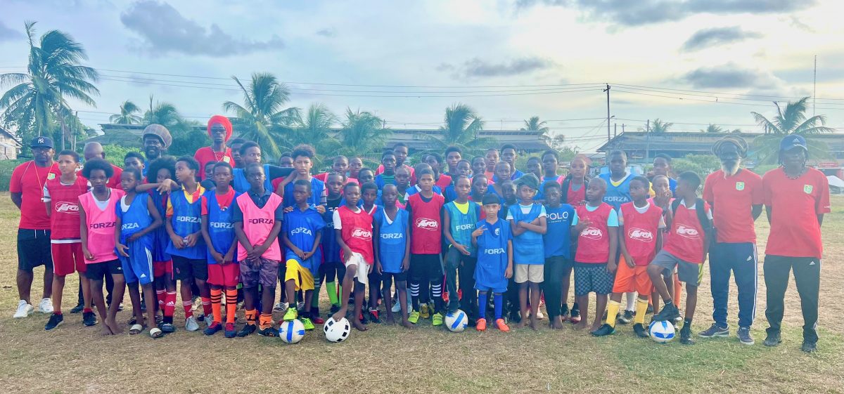 The respective coaches and participants of the on-field segment of the Access Grassroots Programme pose for a photo opportunity on Sunday at the St. Pius Grounds in Georgetown