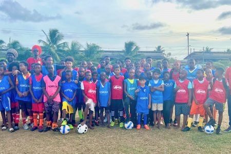 The respective coaches and participants of the on-field segment of the Access Grassroots Programme pose for a photo opportunity on Sunday at the St. Pius Grounds in Georgetown