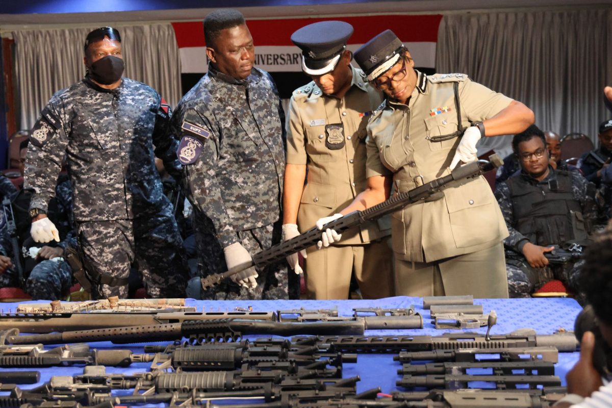 CoP Erla Harewood-Christopher, right, looks at one of the seized guns with ACP Oswain Subero and Guard and Emergency Branch Snr Supt Earl Elie, centre, at the Police Administration Building in Port-of-Spain yesterday. Also in photo, at left, is Snr Supt Roger Alexander.
