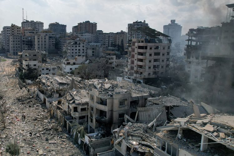 A view shows smoke near houses and buildings destroyed by Israeli strikes in Gaza City, October 10, 2023. REUTERS/Shadi Tabatibi