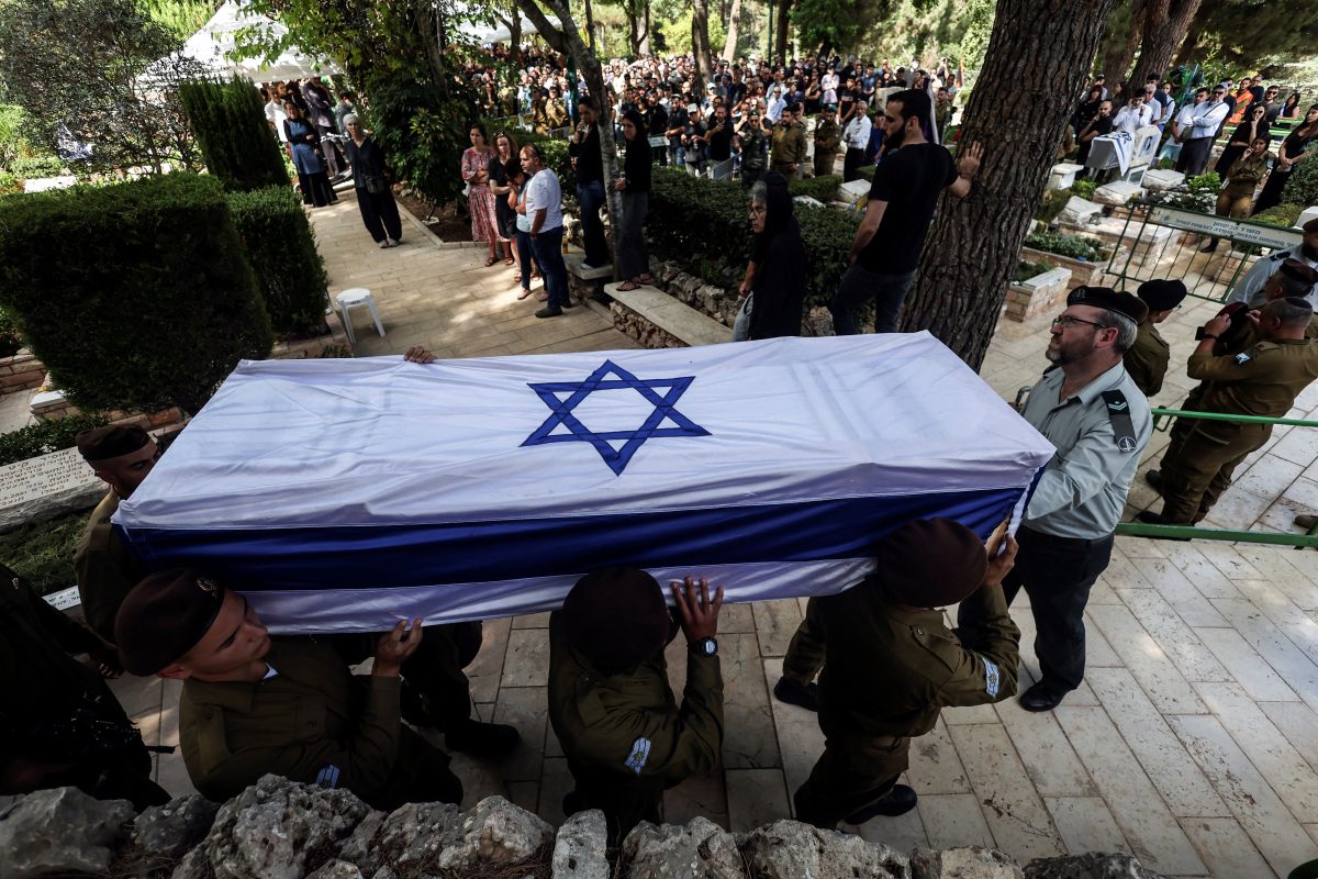 Soldiers carry the coffin of Adi Zur, a soldier who was slain in the assault on Israel by Hamas gunmen from the Gaza Strip, at their funeral at Mount Herzl Military Cemetery in Jerusalem, October 11. REUTERS/Ronen Zvulun