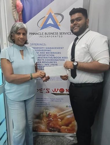 Jade’s Wok Matthew Rupnarain presents the sponsorship cheque to GCF Company Secretary Marcia Lee