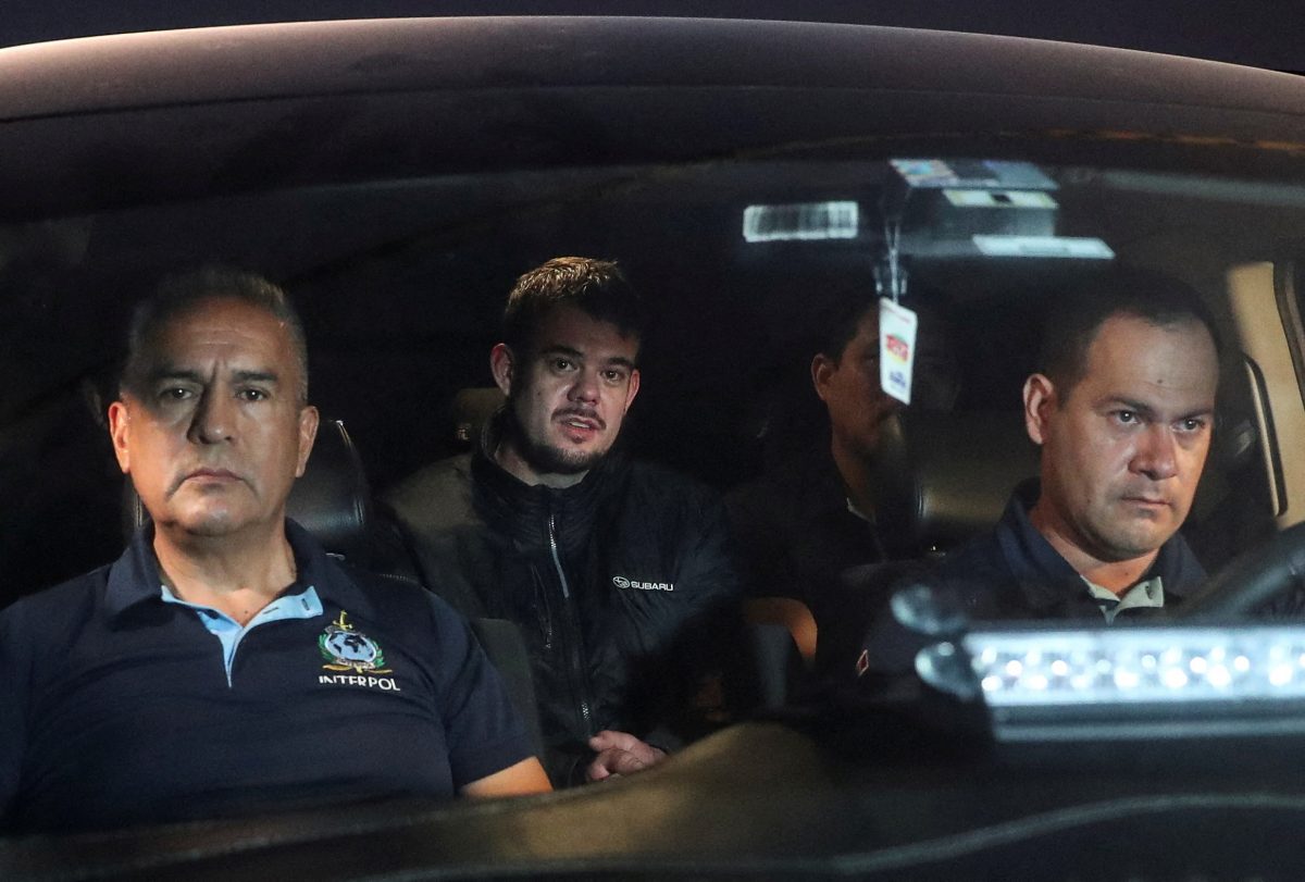 FILE PHOTO: Dutch citizen Joran van der Sloot, who was serving a 28-year sentence in Peru after confessing to killing a 21-year-old Peruvian woman, is escorted to the airport to be extradited to the U.S., to face charges of extortion and wire fraud against the family of Natalee Holloway, in a case linked to his alleged involvement in the disappearance of Natalee Holloway in Aruba in 2005, in Lima, Peru June 8, 2023. REUTERS/Sebastian Castaneda/File Photo