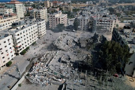 Palestinians gather around residential buildings destroyed in Israeli strikes in Zahra City, amid the ongoing conflict between Israel and Palestinian Islamist group Hamas, in southern Gaza City, October 19, 2023. REUTERS/Shadi Tabatibi