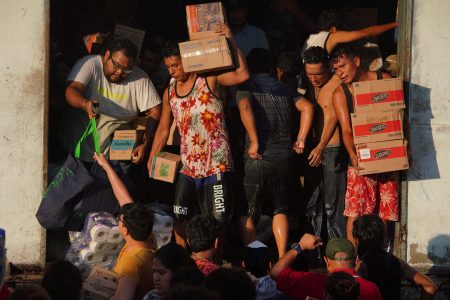 People leave with goods from a supermarket that had been broken into in the aftermath of Hurricane Otis in the outskirts of Acapulco, Mexico, October 26. REUTERS/Alexandre Meneghini