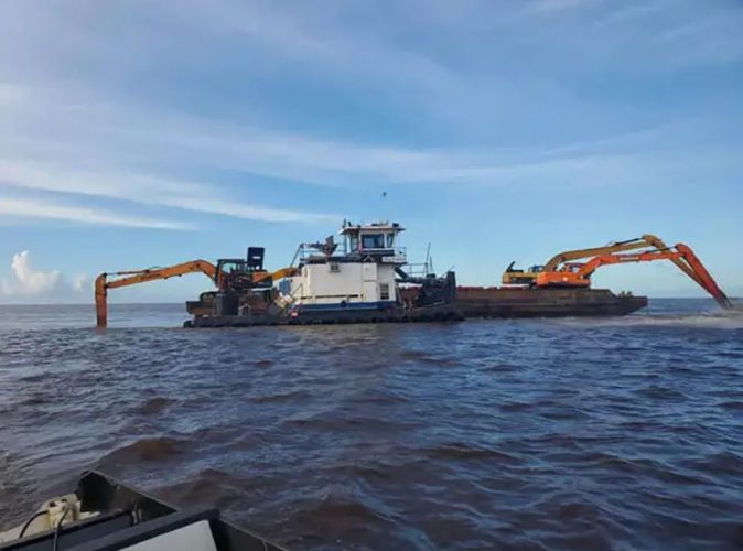 Excavators dredging the Pomeroon River mouth