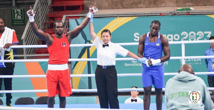 Guyana’s Emmanuel Pompey, right, can’t hide his disappointment after losing a split decision to Antigua’s Tabukuo Aska yesterday in the 96 kg round of 16 bout at the Pan American Games in Santiago, Chile.