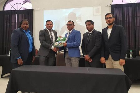 Minister of Natural Resources Vickram Bharrat (second from left) and Chateram Ramdihal (third from left) of Ramdihal and Haynes with the signed agreement for the RHVE audit. (Ministry of Natural Resources photo)