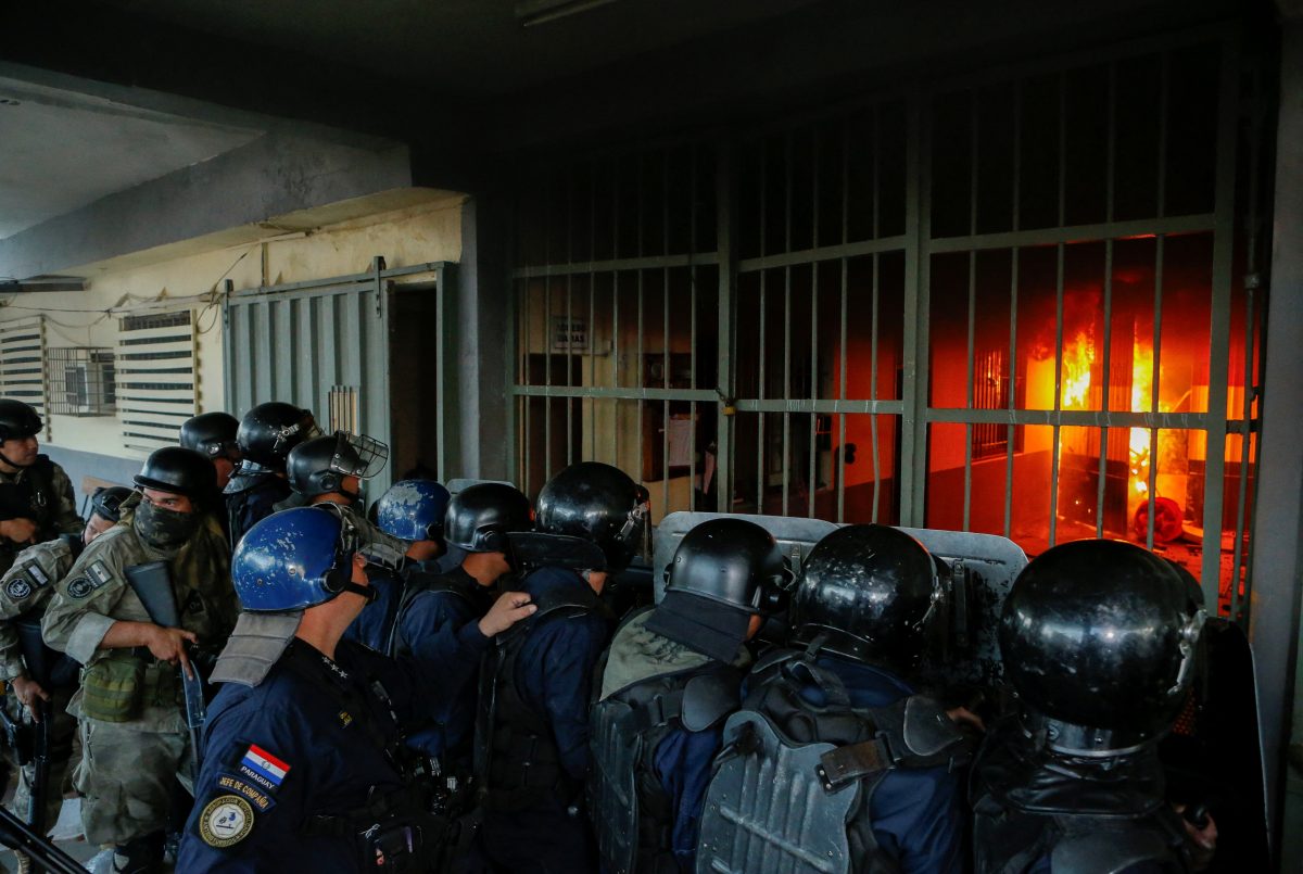 Police stand outside the Tacumbu penitentiary during a riot after inmates took hostage a dozen officials and caused a fire, in Asuncion, Paraguay October 10, 2023. REUTERS/Cesar Olmedo