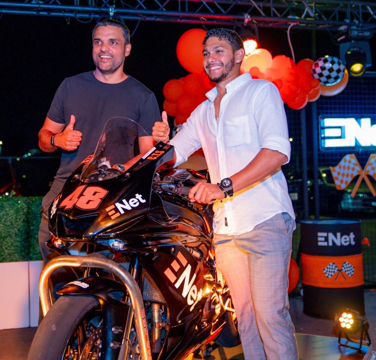Biker Matthew Vieira (right) and CEO of ENet Vishok Persaud pose with the branded Yamaha R6.