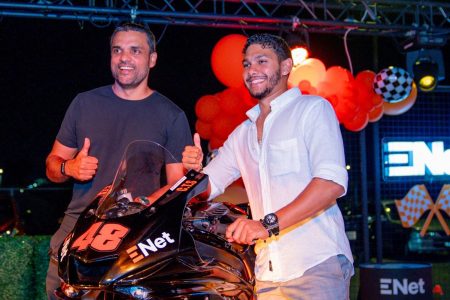 Biker Matthew Vieira (right) and CEO of ENet Vishok Persaud pose with the branded Yamaha R6.