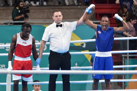Guyana’s Joel Williamson, left, lost by a unanimous decision yesterday to Miguel De La Cruz of the Dominican Republic in his 63.5kg round of 16 bout at the Pan Am Games in Santiago, Chile